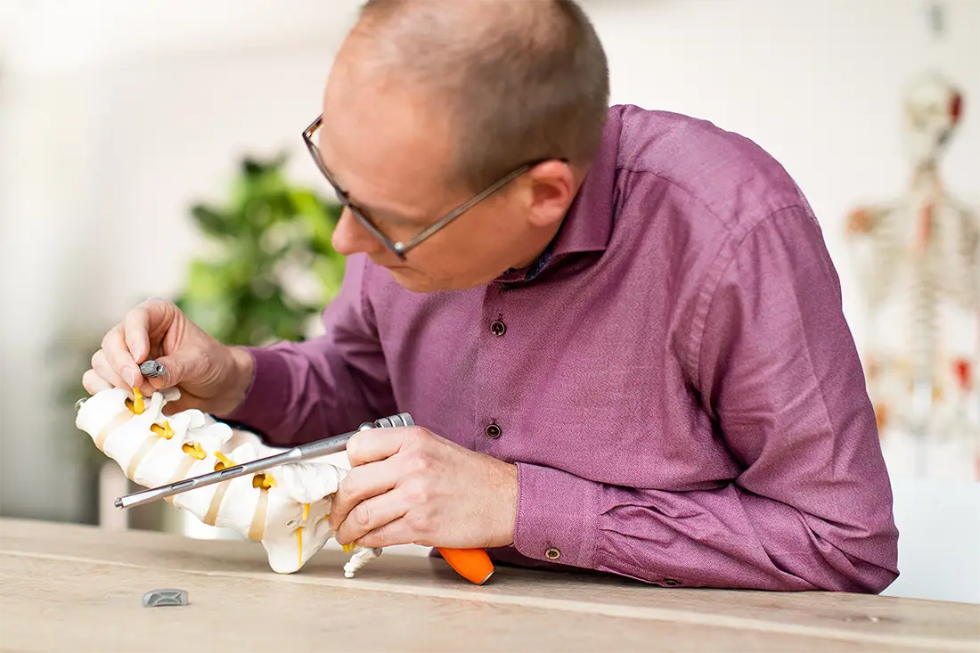 Employee of medical device product development company working on a surgical instrument